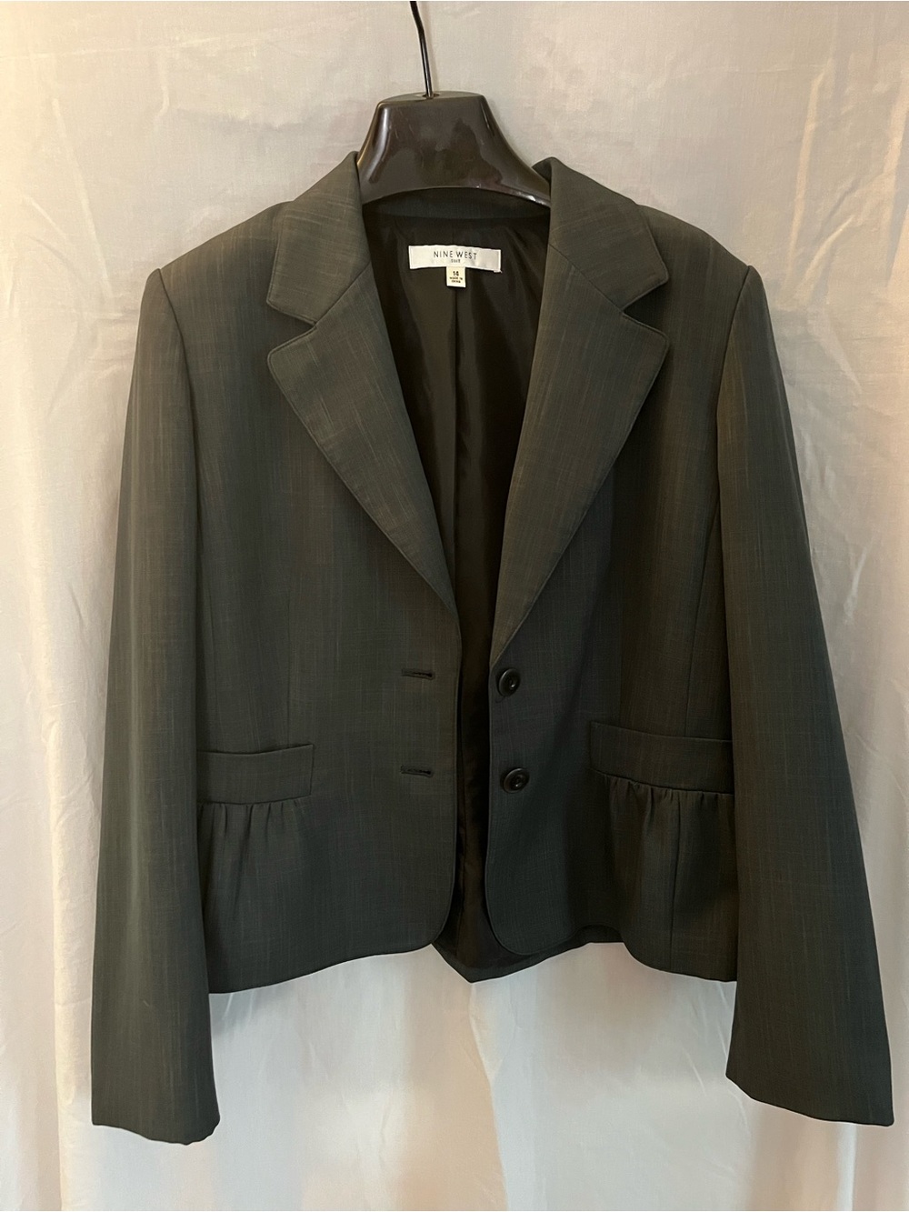 Nine West Charcoal Pinstripe Suit. The suit jacket has two buttons.